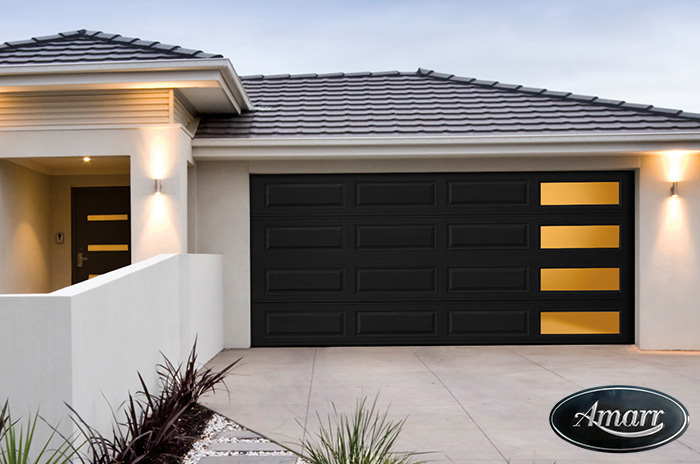 Finished garage door installation on a stone-front home